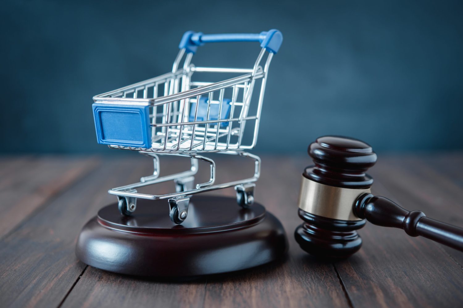 shopping cart and auction hammer on  black  background